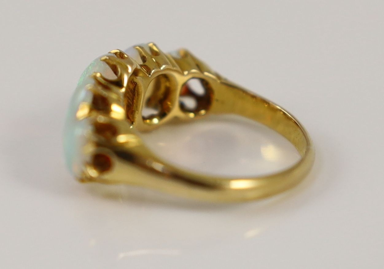 An Edwardian 18ct gold and five stone graduated white opal set half hoop ring